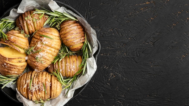 Free photo flat lay of potatoes in pan with rosemary and copy space