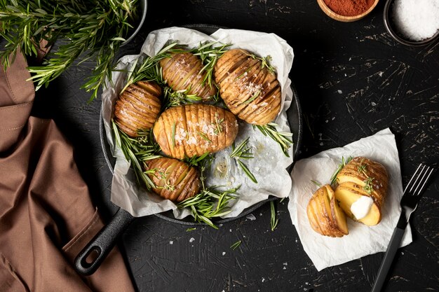 Flat lay of potatoes in pan with rosemary and other spices
