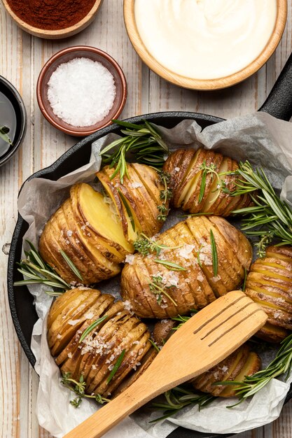 Flat lay of potatoes in pan with rosemary and spices