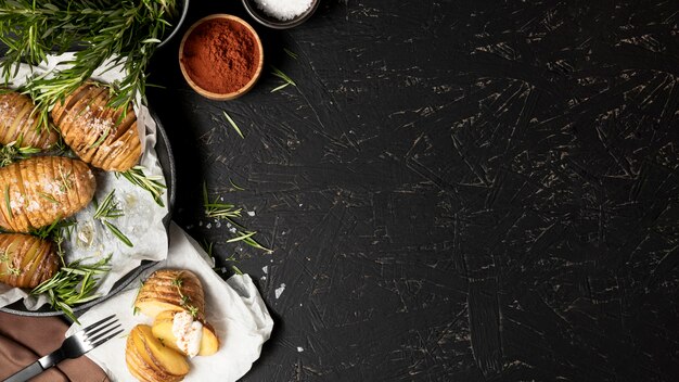 Flat lay of potatoes in pan with spices and copy space