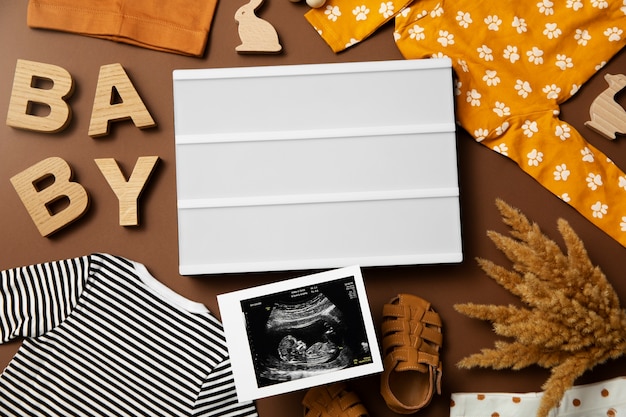 Flat lay pregnancy announcement with baby items