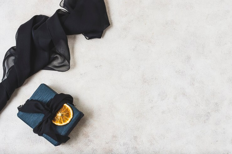 Free Photo flat lay of present with citrus slice and copy space