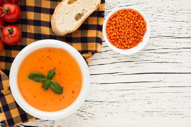 Flat lay pumpkin bisque bread and lentil bowl with copy space