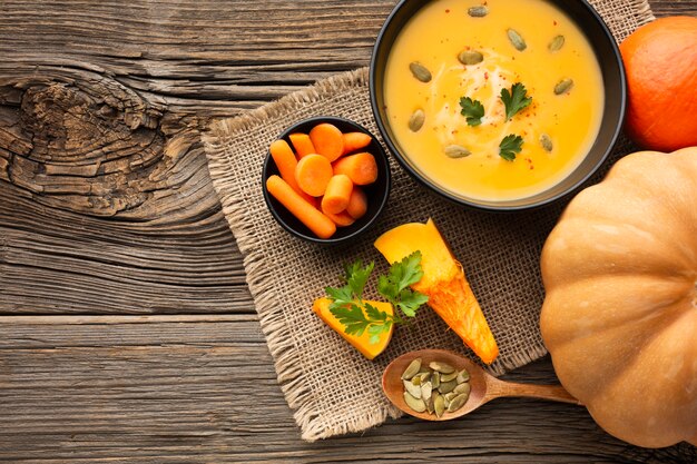 Flat lay pumpkin soup with carrots and pumpkin