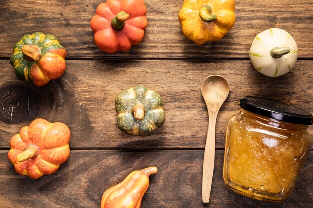 Flat lay pumpkins arrangement  with jam jar and spoon