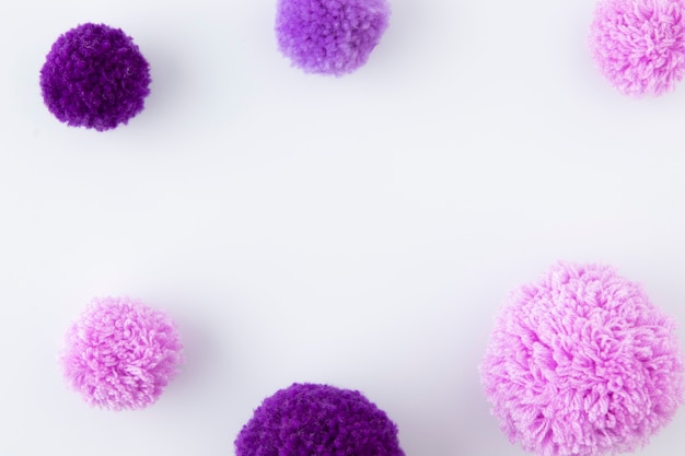 Flat lay purple pom poms arrangement