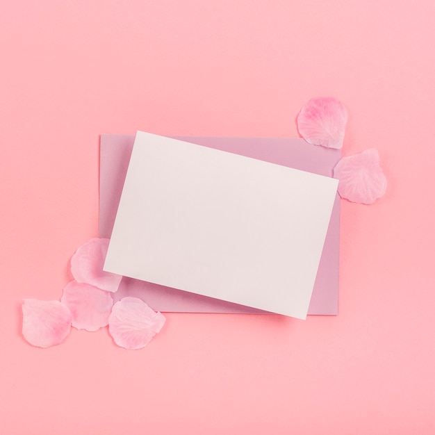 Flat lay quinceañera arrangement with empty card and envelope