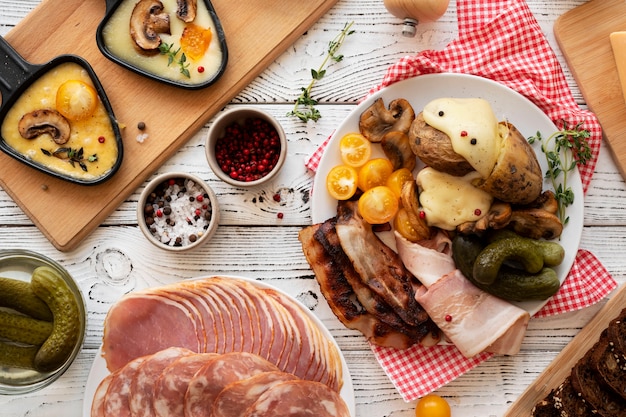 Flat lay of raclette dish with delicious food assortment