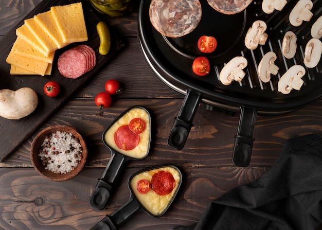 Flat lay of raclette dish with delicious food assortment