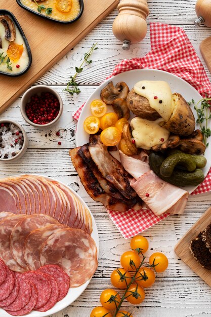 Flat lay of raclette dish with delicious food assortment