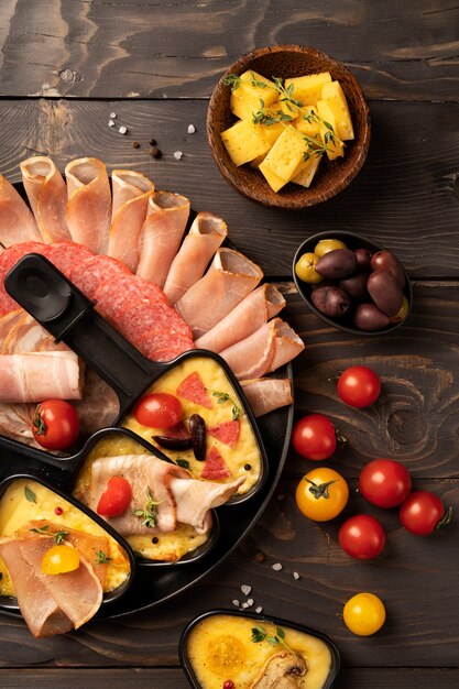 Flat lay of raclette dish with delicious food assortment