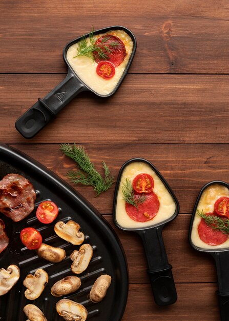 Flat lay of raclette dish with delicious food assortment