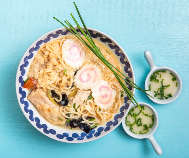 Flat lay ramen soup and saucers