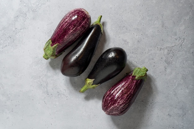 Free photo flat lay raw eggplants still life