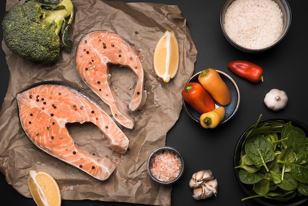 Flat lay raw salmon steak and ingredients