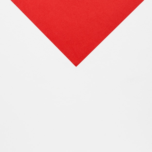 Flat lay red arrowhead on white background
