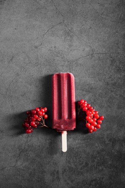 Flat lay red flavored ice cream on stick