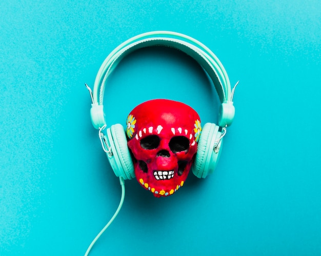 Flat lay red skull with headphones