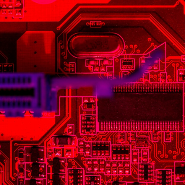 Flat lay of red themed circuit board with chip