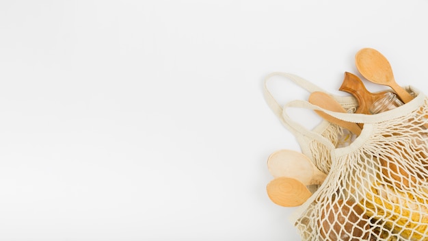 Flat lay of reusable bag with wooden spoons