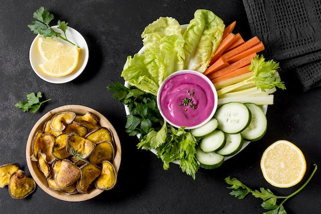 Flat lay of roasted potatoes in bowl with vegetables