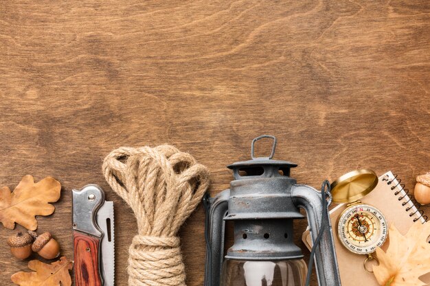 Flat lay of rope with lantern and autumn leaves