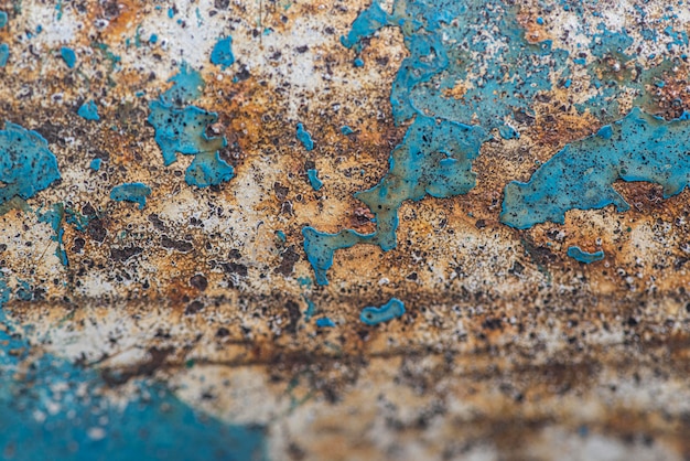Flat lay of rusty metal surface with paint peel