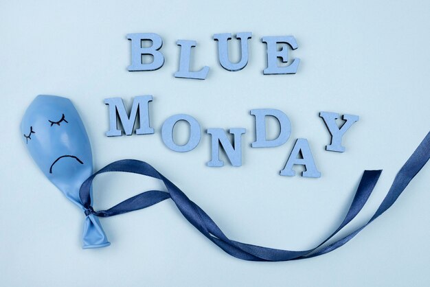 flat lay of sad blue monday balloon with ribbon