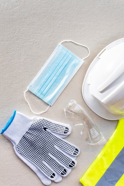 Flat lay safety construction gloves and medical mask