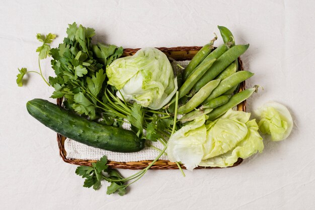 Flat lay of salad and assortment of vegetables in basket