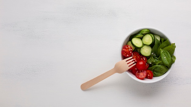 Flat lay of salad bowl on white background