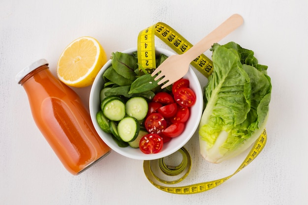 Flat lay of salad and juice bottle