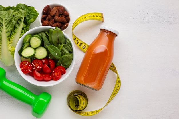 Flat lay of salad and natural juice