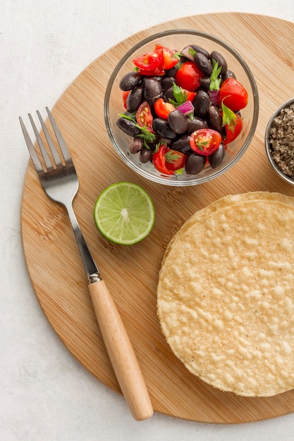 Flat lay salad with black beans and tortillas