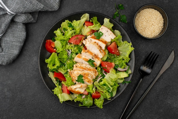 Flat lay salad with chicken and sesame seeds