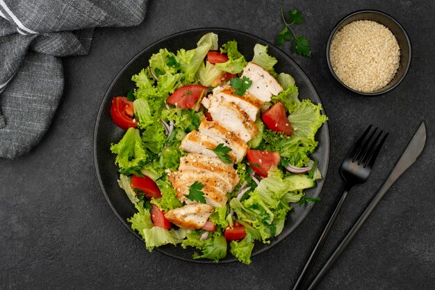 Flat lay salad with chicken and sesame seeds