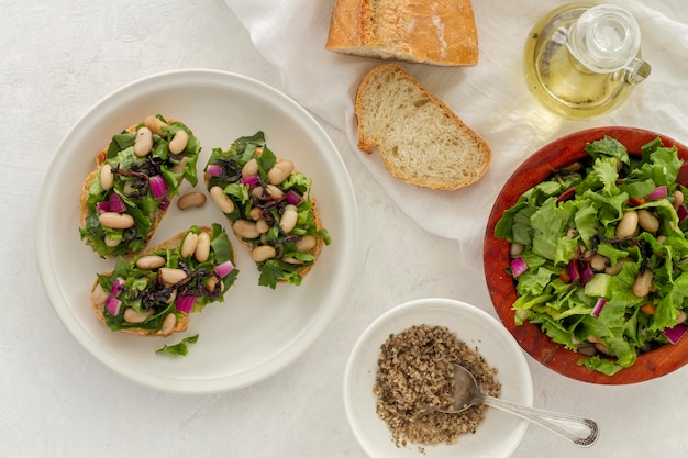 Flat lay salad with white beans on bread