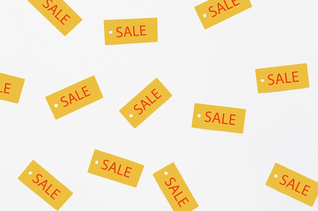 Free photo flat lay of sale tags on plain background