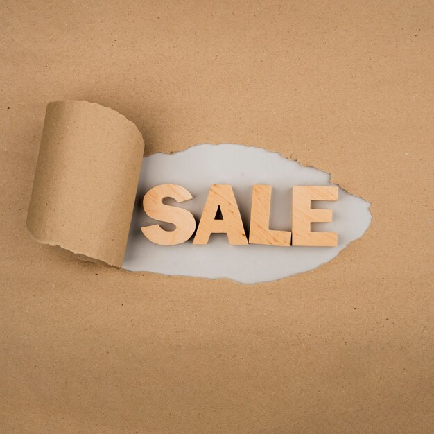 Flat lay of sale word on craft paper