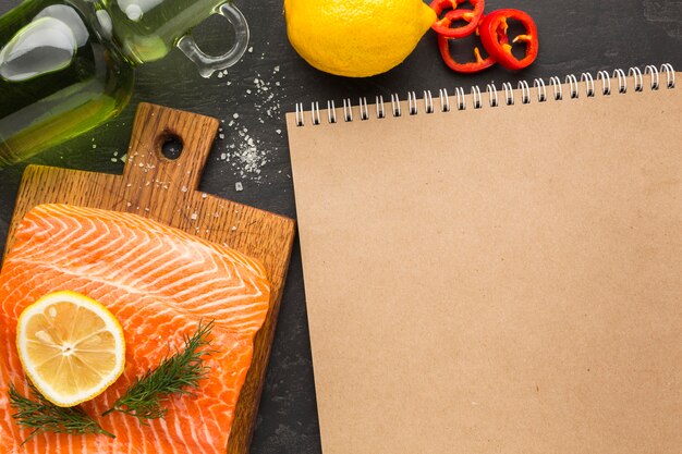 Flat lay salmon and notebook arrangement