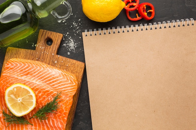 Flat lay salmon and notebook arrangement