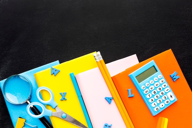 Flat lay of school essentials with books and calculator