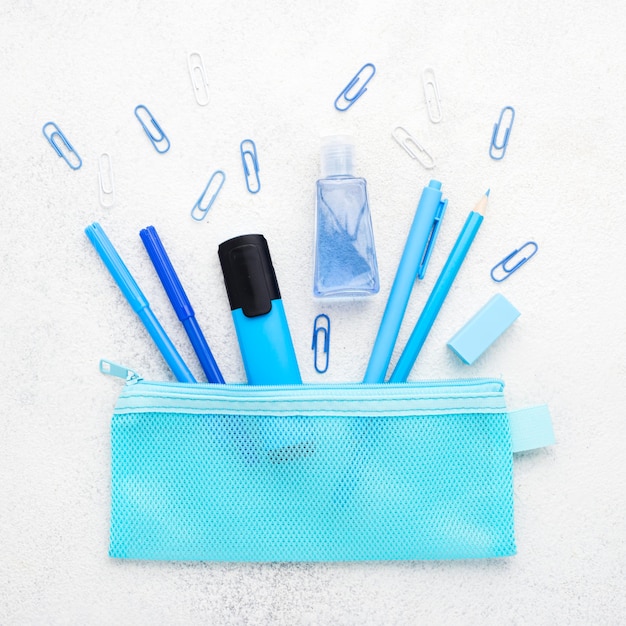 Free photo flat lay of school essentials with paper clips and pencils