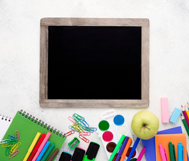 Flat lay of school essentials with pencils and blackboard