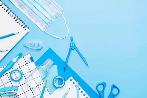 Flat lay school items on blue background