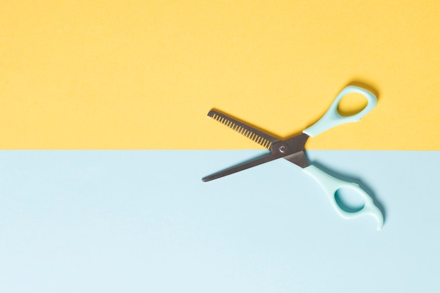 Flat lay of scissors on plain background
