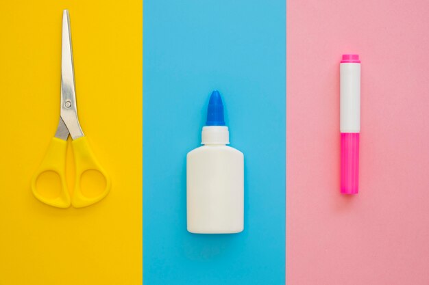 Flat lay of scissors with correction fluid and marker