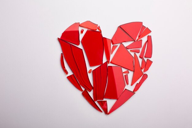 Free photo flat lay shattered red glass heart