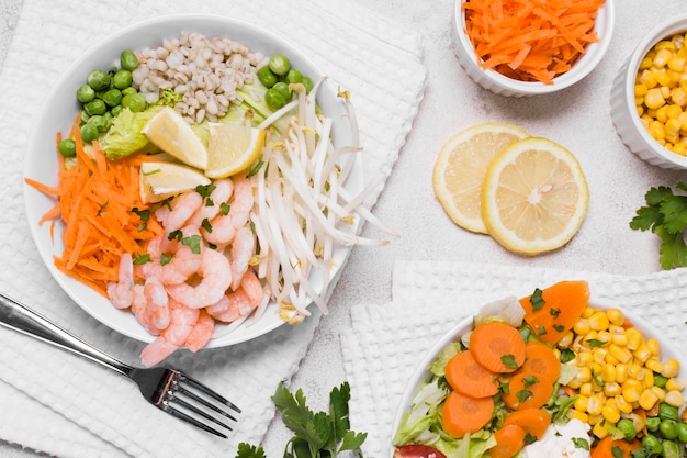 Flat lay of shrimp and vegetables on plates