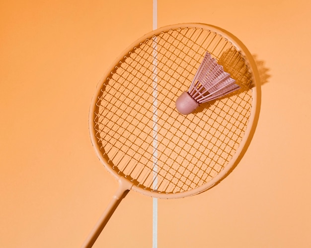 Free photo flat lay shuttlecock on badminton racket